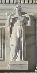 Marble statue of woman holding lamp
