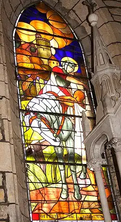 A stained-glass window, inside the church of Mayrac, of Saint Martin sharing his coat by Georges Lebacq