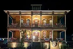 Showing the front façade of the Vogt House at night on 8 August 2024