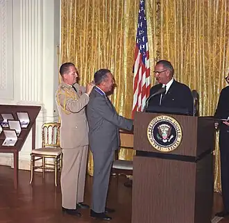 Walt Disney receiving the Presidential Medal of Freedom from President Lyndon B. Johnson, 1964