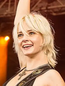 Headshot of Milkie Way performing with an electric guitar.