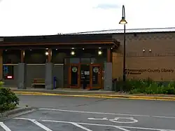 The Wayzata Library, a traditional brick building with square columns and a street lamp.