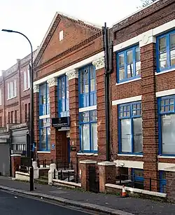 exterior of red brick building with classical-style columns and pediment