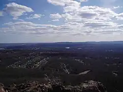 View looking south from the top of West Peak in Meriden, Connecticut. Sleeping Giant State Park can be seen.