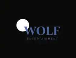 Wolf Entertainment logo featuring a stylized white crescent moon partially overlapping the word "WOLF" in blue uppercase letters, with "ENTERTAINMENT" in smaller blue text underneath, all set against a black background.