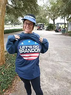 A woman wearing a shirt with the slogan