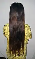 An Indonesian woman with hip/tailbone length hair