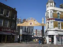 Woolwich New Road entrance with Victorian buildings and market portal