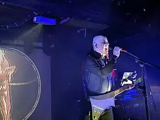 Performer on stage signing into a microphone