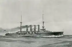 A large ship steams at high speed through choppy seas, creating a large white wave at the bow