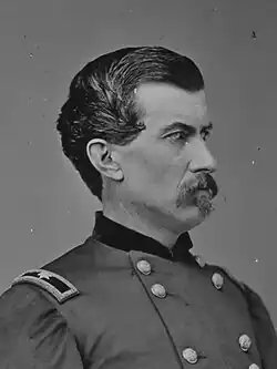 Head and shoulders portrait white man in a military uniform facing right
