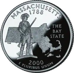 A nickle coin bearing the statue of a man in 18th-century clothing. He holds a rifle, and his coat is on a plow beside him. Behind the man is the outline of Massachusetts. Above the image is inscribed "Massachusetts" and "1788." Beside the image is inscribed "The Bay State." Below the image is inscribed "2000" and "E pluribus unum".