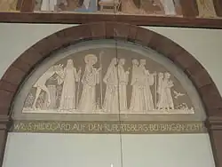 "Wie S. Hildegard auf den Rupertsberg bei Bingen zieht." ("Como santa Hildegarda parte de Rupertsberg hacia Bingen").