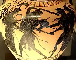 Ánfora de cerámica de figuras negras, que representa la disputa entre Apolo y Heracles por el trípode de Delfos. Relacionada con el denominado Grupo de Toronto 305. Hacia 510 a. C.[78]​