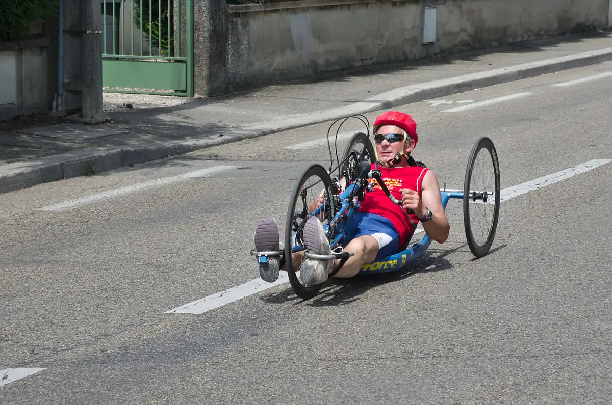Corredor con casco de color rojo sobre una "hand bike": categoría MH4