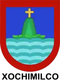 Escudo otorgado a la entonces ciudad de Xochimilco el 4 de marzo de 1559 por Felipe II. Usado durante el régimen municipal cuando Xochimilco fue cabecera de municipio o prefectura, es objeto actualmente de una especie de disputa entre Milpa Alta y Xochimilco.[13]​
