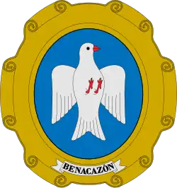 Escudo del municipio español de Benacazón: «En campo ovalado de azul celeste, una paloma blanca»