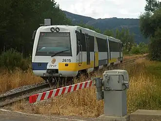 Tren en una vía recta en un fondo montañoso
