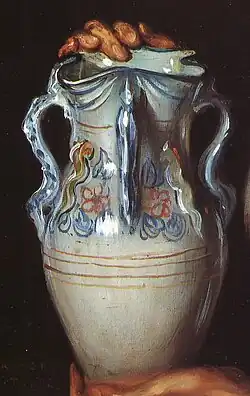 Tres de las asas de una jarra de cuatro picos, muy similar a las que en Andújar llaman "jarra de estudiante". Detalle del cuadro La niña de la jarra, pintado en 1928 por Julio Romero de Torres.