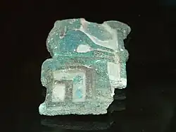 Fragmentary relief of green glaze showing a woman seated.