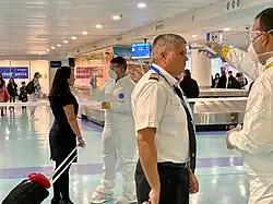 Médicos inspeccionando a personal del aeropuerto