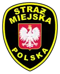 Insignia de la policía municipal polaca (Straż Miejska), utilizando Ƶ barrada como variante de Ż