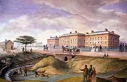 A painting of the Parliament Buildings of Upper Canada, depicted in brown in the background facing leftward while people mingle along a road and creek in the foreground.