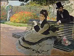 Camille Monet en un banco en el jardín.